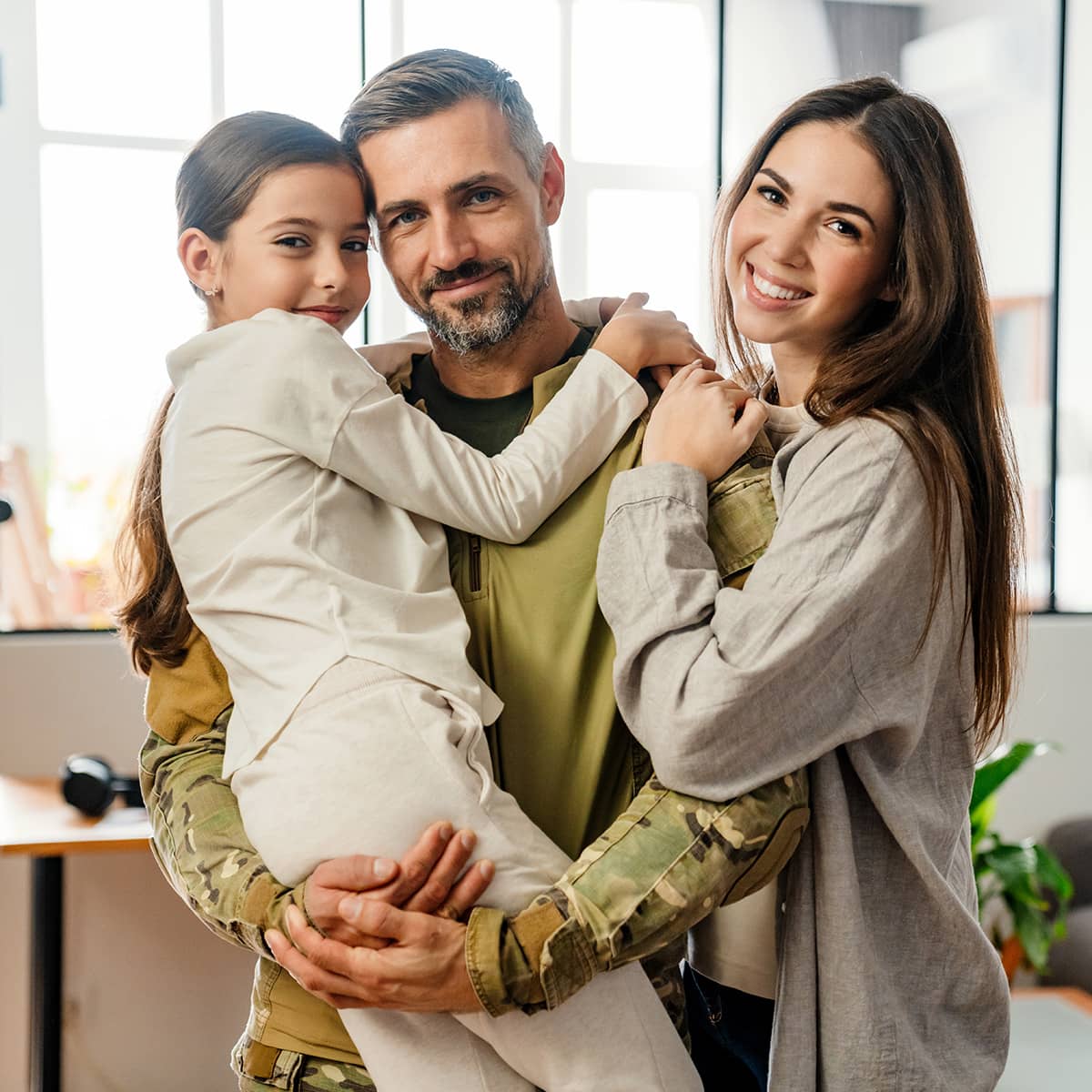 A family smiling with the father holding the child